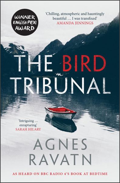 Cover of The Bird Tribunal by Agnes Ravatn: a small rowing boat with no one in it sits on the water in a fjord. The interior of the boat is red with the rest of the image in monochrome.